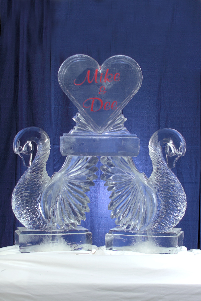 Double Swans Holding a Heart